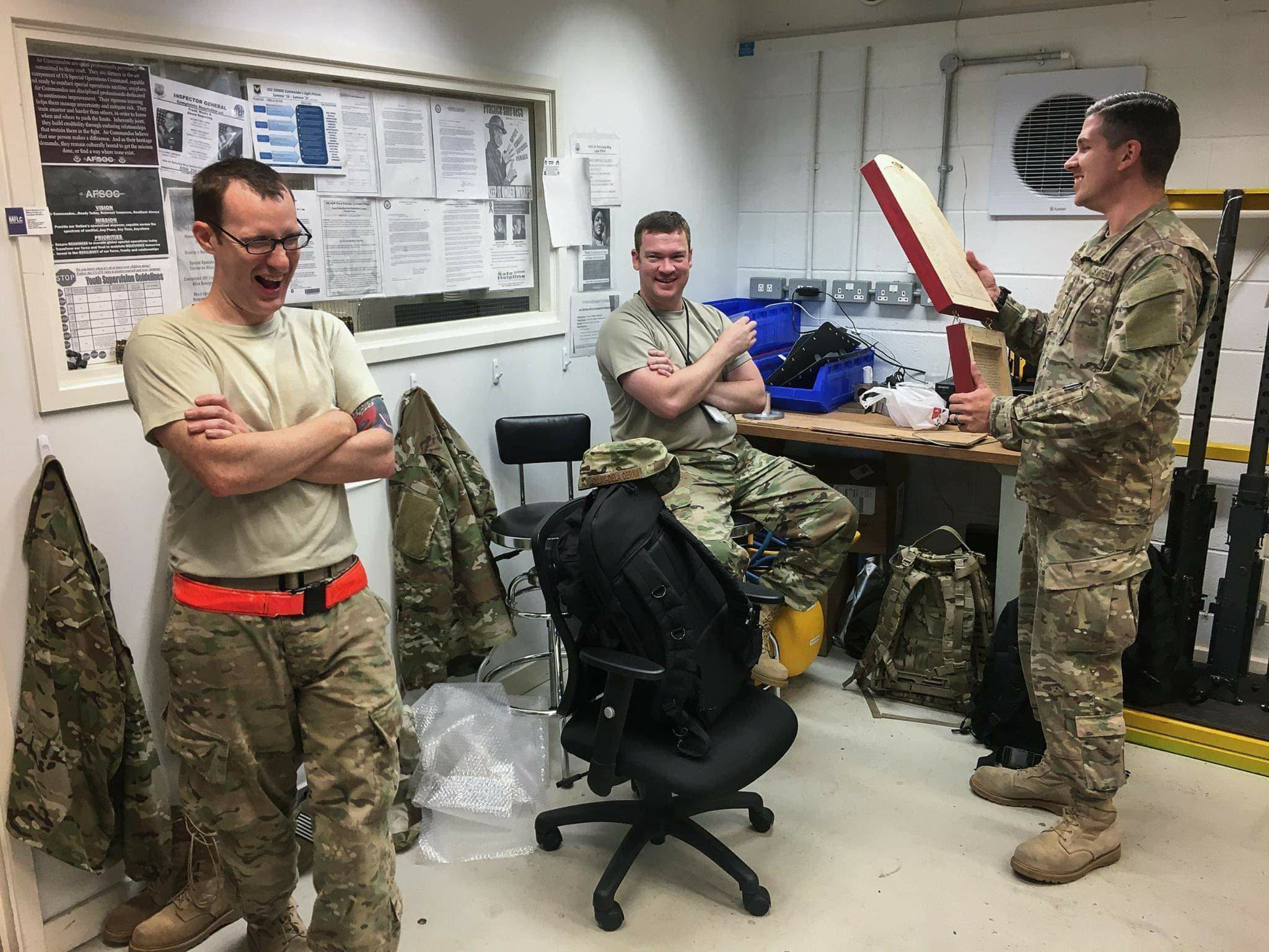 Todd laughing with coworkers during a chaotic work moment